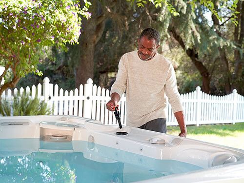 caldera-spas-paradise-series-reunion-model-arctic-white-ash-lifestyle-couple-water-care-moblie